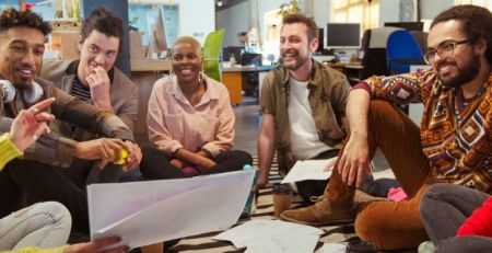 A group of Gen Z employees in a laid-back office setting.